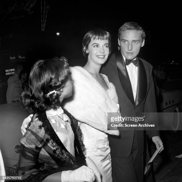 Natalie Wood with arm around sister Lana Wood with date Dennis Hopper at Hollywood event circa 1955.