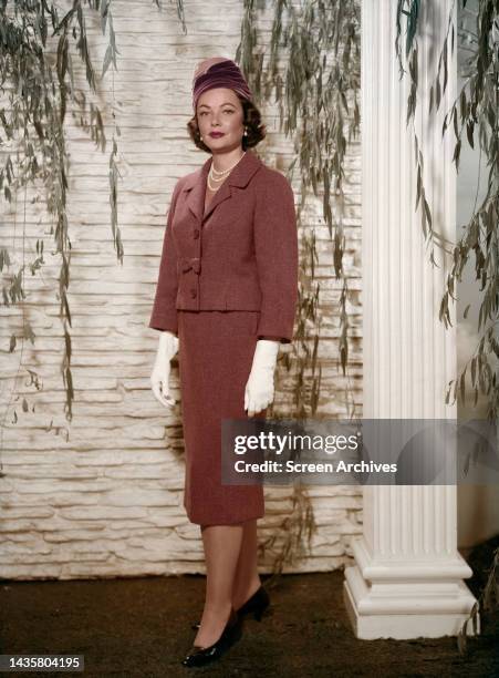 Gene Tierney vintage studio portrait in elegant outfit.