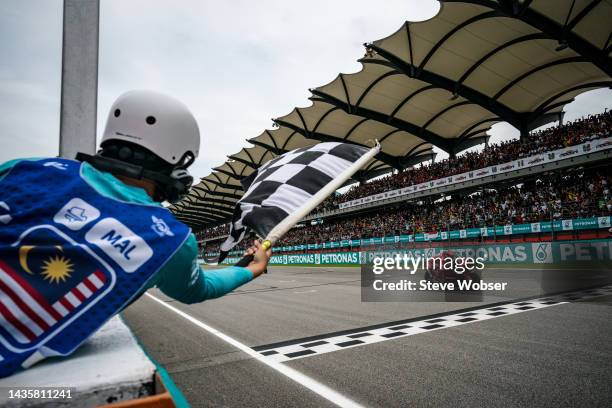 Francesco Bagnaia of Italy and Ducati Lenovo Team crosses the finish line next to the checkered flag and wins the race during the race of the MotoGP...