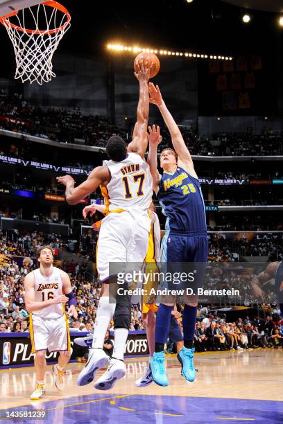 Andrew Bynum of the Los Angeles Lakers blocks a shot attempt by Timofey Mozgov of the Denver Nuggets in Game One of the Western Conference...