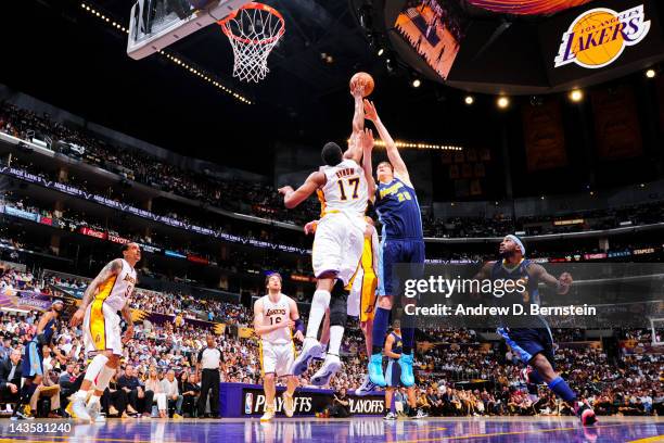 Andrew Bynum of the Los Angeles Lakers blocks a shot attempt by Timofey Mozgov of the Denver Nuggets in Game One of the Western Conference...