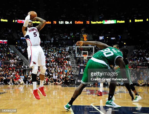 Josh Smith of the Atlanta Hawks shoots over Brandon Bass of the Boston Celtics in Game One of the Eastern Conference Quarterfinals in the 2012 NBA...