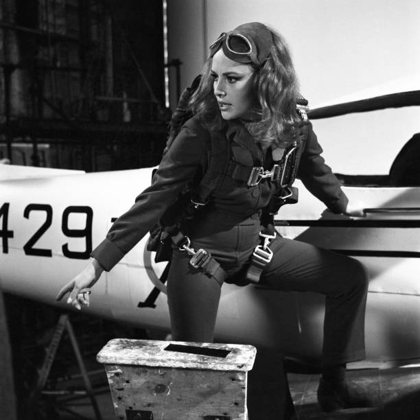 Karin Dor with parachute strapped to body standing by light aircraft in a scene from the 1967 James Bond film You Only Live Twice.