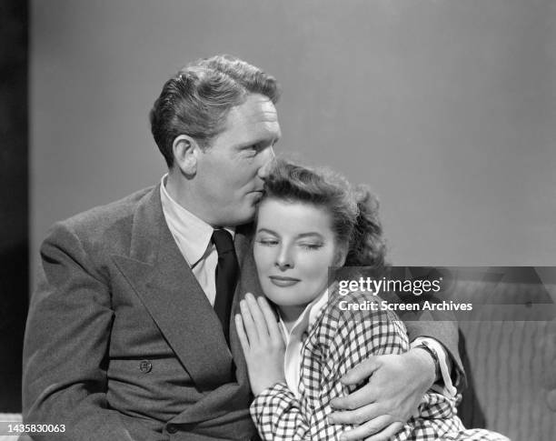 Spencer Tracy tenderly kisses Katharine Hepburn on the forehead in a 1941 publicity portrait for their 1942 release Woman of the Year.