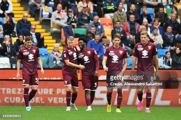 Ola Aina of Torino FC celebrates with teammates after scoring their team's first goal during the Serie A match between Udinese Calcio and Torino FC...