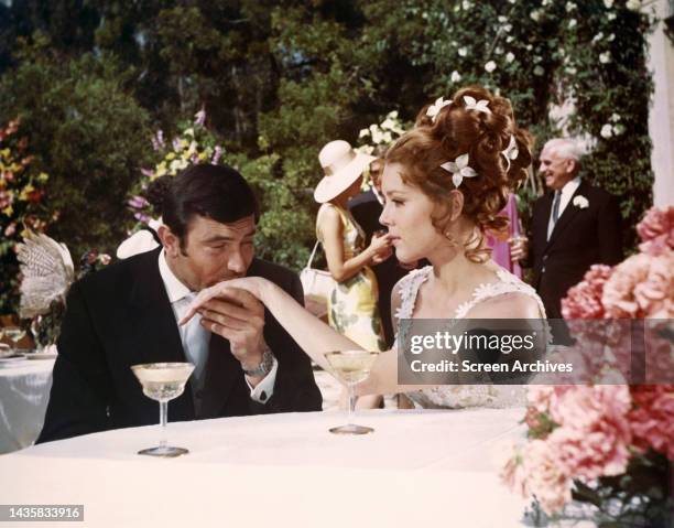 On Her Majesty's Secret Service George Lazenby as James Bond kisses his bride Diana Rigg hand from the 1969 movie.