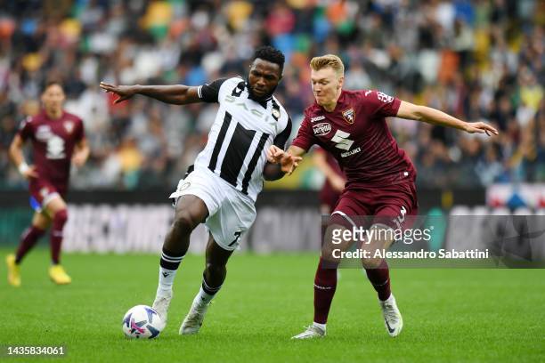 Isaac Success of Udinese Calcio and Perr Schuurs of Torino FC battle for the ball during the Serie A match between Udinese Calcio and Torino FC at...