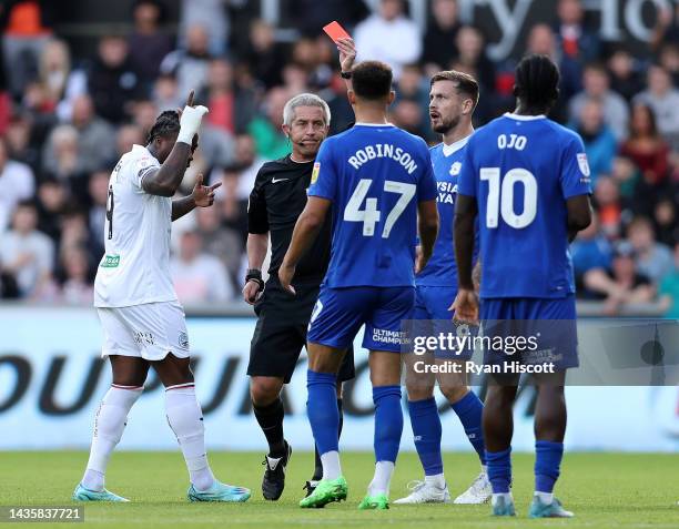 Callum Robinson of Cardiff City receives a red card from Referee Darren Bond during the Sky Bet Championship between Swansea City and Cardiff City at...