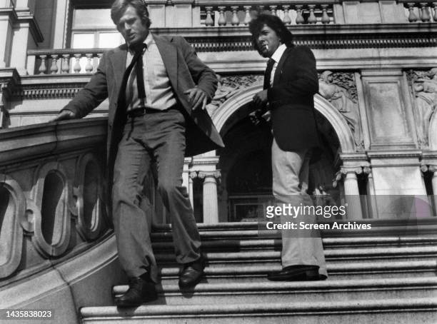 All The President's Men Robert Redford rushes down steps as Dustin Hoffman looks on in a scene from the political drama film 1976.