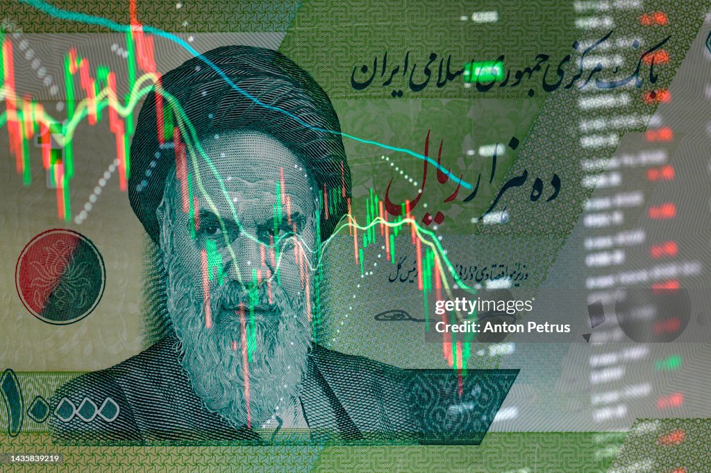 Iranian rials banknote on the background of stock charts. Economic sanctions in Iran