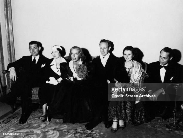 Clark Gable ,Joan Crawford, Leslie Howard, Franchot Tone and Heather Angel pictured posing on couch circa 1935.