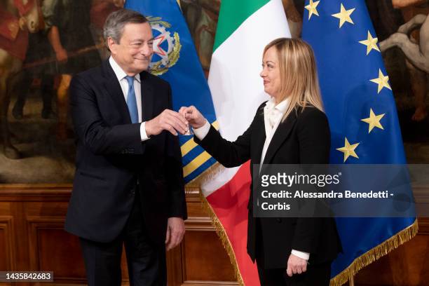 Italy's new Prime Minister Giorgia Meloni rings the received bell from outgoing Prime Minister Mario Draghi, prior her first Ministry Council meeting...