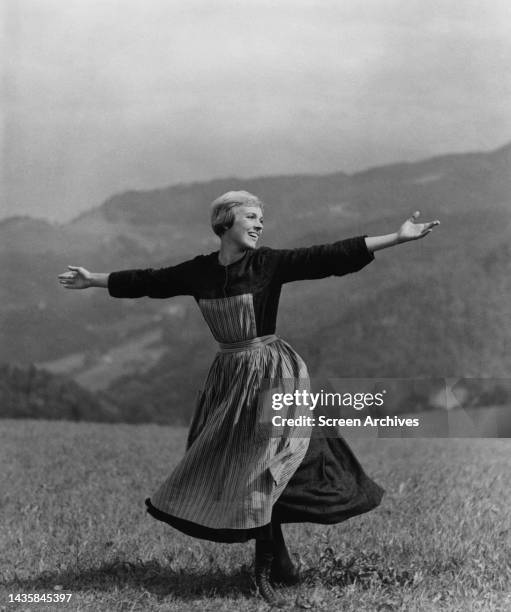 Julie Andrews singing on hilltop from the classic 1965 musical The Sound of Music.