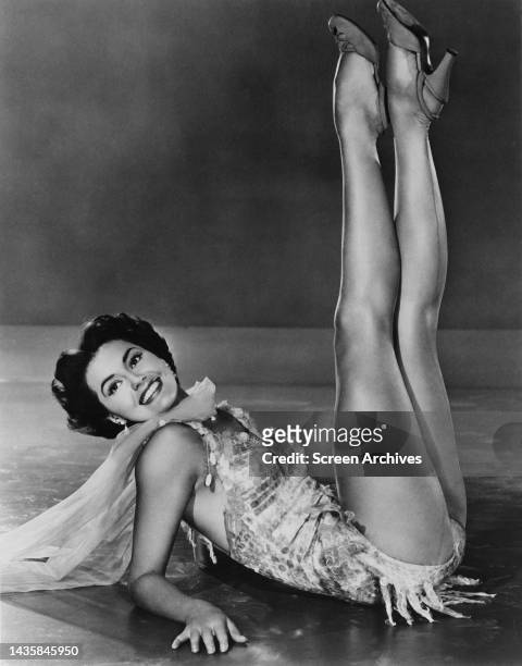 Cyd Charisse Leggy MGM glamour publicity pose with legs in the air circa 1955.