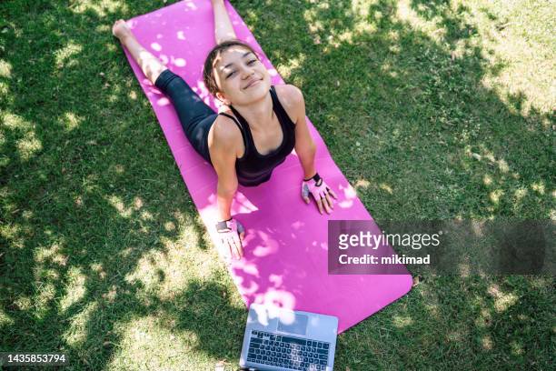 teenage girl doing yoga and stretching at home in back yard. copy space. - teenager yoga stock pictures, royalty-free photos & images