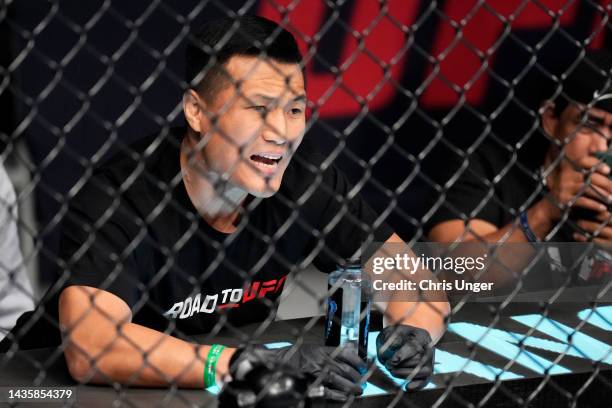 The Korean Zombie' Chan Sung Jung is seen in the corner of SeungGuk Choi of South Korea during his flyweight fight against Qiu Lun of China during...