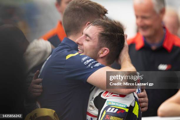 John McPhee of Great Britain and Sterilgarda Husquarna Max Team celebrates the victory under the podium with team during the Moto3 race during the...