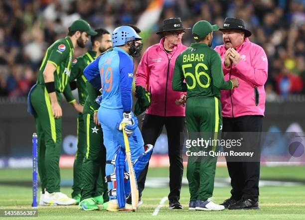 Babar Azam the captain of Pakistan speaks to the umpires after a no ball decision in the last over during the ICC Men's T20 World Cup match between...