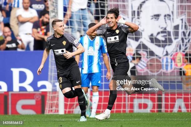 Pere Milla of Elche CF celebrates with teammate Carlos Clerc after scoring their team's first goal during the LaLiga Santander match between RCD...