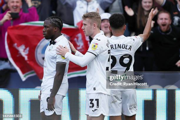 Michael Obafemi of Swansea City celebrates scoring their side's second goal with teammates Ollie Cooper and Matthew Sorinola during the Sky Bet...