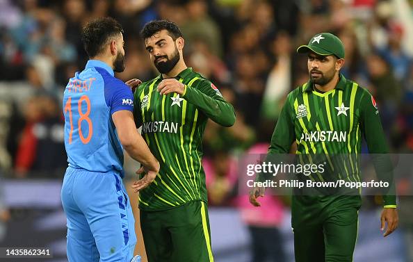 Shadab Khan and Babar Azam of Pakistan congratulate Virat Kohli