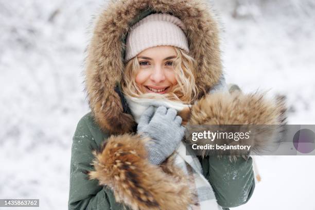 portrait of beautiful young woman in warm clothes in winter forest - fur glove stock pictures, royalty-free photos & images