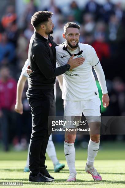 Russell Martin, Manager of Swansea City, celebrates with Matt Grimes of Swansea City after the final whistle of the Sky Bet Championship between...