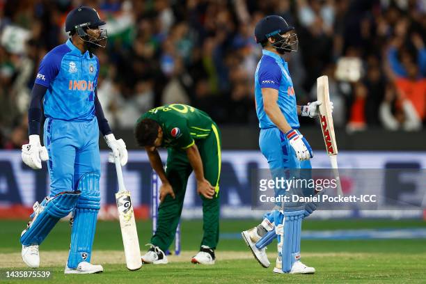 Haris Rauf of Pakistan reacts as Virat Kohli and Hardik Pandya of India celebrate a boundary during the ICC Men's T20 World Cup match between India...