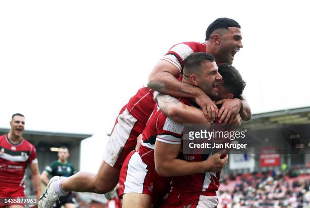 Brandon Morkos of Lebanon celebrates their sides third try with team mate Josh Mansour during the Rugby League World Cup 2021 Pool C match between...