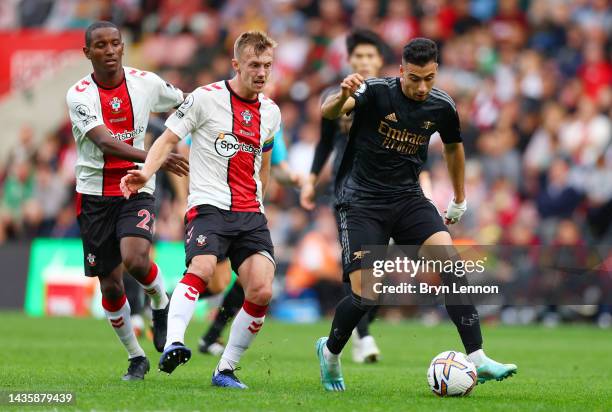 Gabriel Martinelli of Arsenal is challenged by James Ward-Prowse and Ibrahima Diallo of Southampton during the Premier League match between...