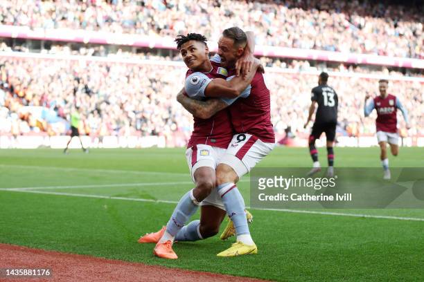 Ollie Watkins of Aston Villa celebrates with teammate Danny Ings after scoring their team's fourth goal during the Premier League match between Aston...