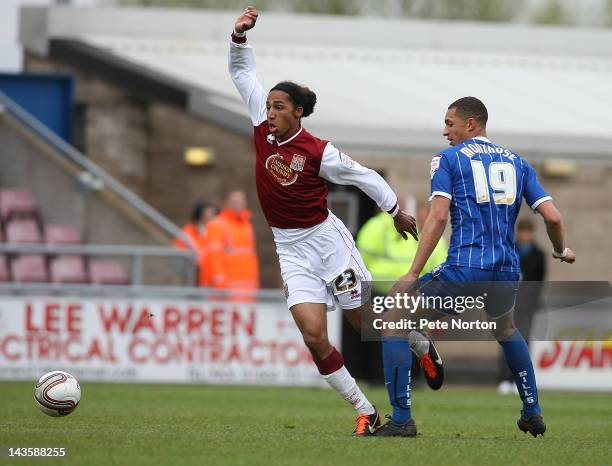 Lewis Wilson of Northampton Town moves away with the ball from Lewis Montrose of Gillingham during the League Two match between Northampton Town and...