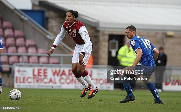 Lewis Wilson of Northampton Town moves away with the ball from Lewis Montrose of Gillingham during the League Two match between Northampton Town and...