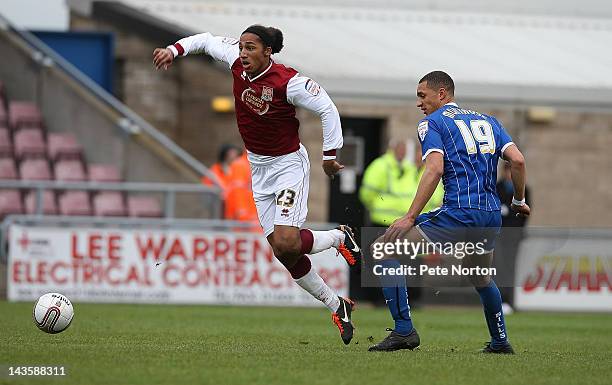 Lewis Wilson of Northampton Town moves away with the ball from Lewis Montrose of Gillingham during the League Two match between Northampton Town and...
