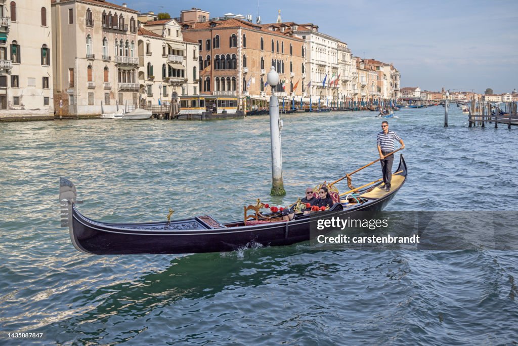 Tourists in a gondola on a large canal