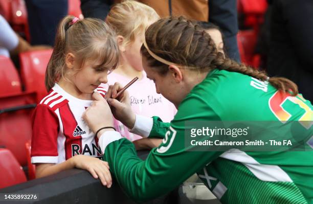 Bethan Davies of Sheffield United signs a shirt for a fan after their sides defeat during the Barclays FA Women's Championship match between...