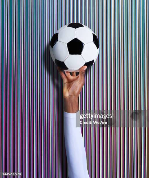 male hand holding football - trainer cutout stockfoto's en -beelden