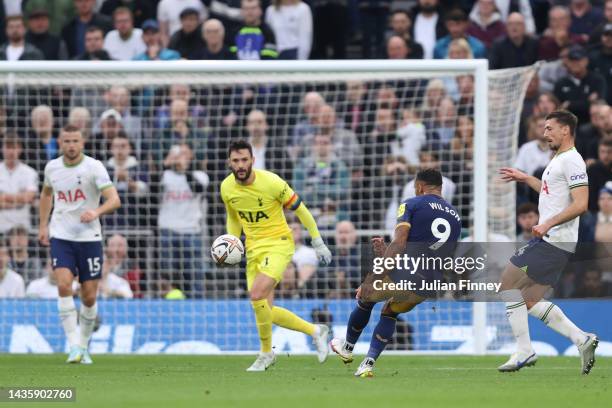 Callum Wilson of Newcastle United scores their team's first goal past Hugo Lloris of Tottenham Hotspur during the Premier League match between...