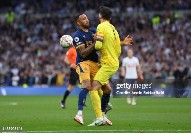 Callum Wilson of Newcastle United clashes with Hugo Lloris of Tottenham Hotspur before they scored their sides first goal during the Premier League...