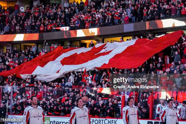 Large Canadian flag is passed through the crowd during the national anthems prior to a game between the Ottawa Senators and the Washington Capitals...