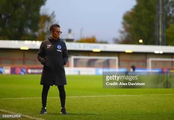Hope Powell, Manager of Brighton & Hove Albion looks on as match officials inspect the pitch prior to the FA Women's Super League match between...