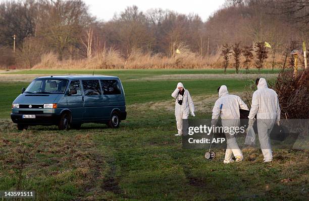 Picture taken on January 13, 2012 shows policemen securing evidences on a golf course in Grossensee near Hamburg, northern Germany, in connection...