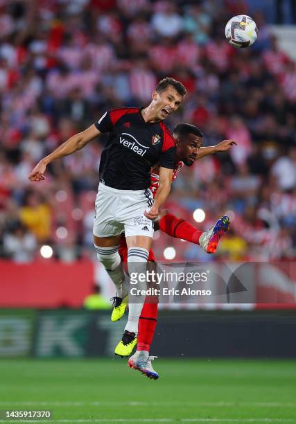 Lucas Torro of Osasuna jumps for the ball with Yangel Herrera of Girona FC during the LaLiga Santander match between Girona FC and CA Osasuna at...
