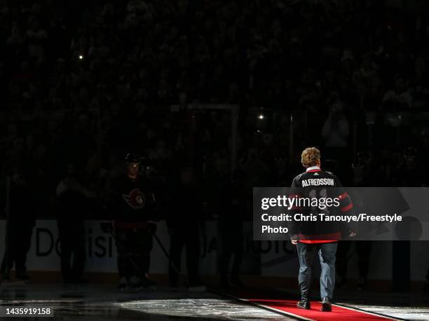 Former Ottawa Senators player Daniel Alfredsson salutes the crowd prior to a ceremonial face-off during the home opener against the Boston Bruins at...