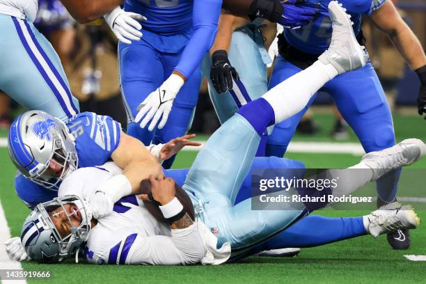 Levi Onwuzurike of the Detroit Lions tackles Dak Prescott of the Dallas Cowboys during the first quarter at AT&T Stadium on October 23, 2022 in...