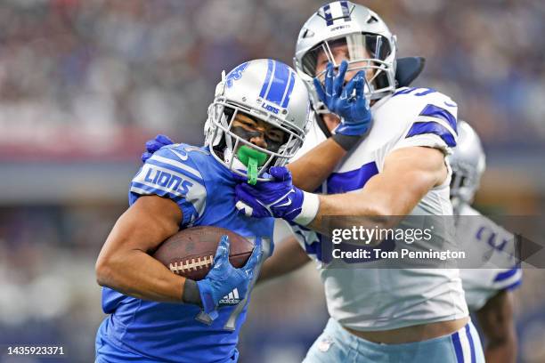 Kalif Raymond of the Detroit Lions runs with the ball as he stiff arms Leighton Vander Esch of the Dallas Cowboys during the first quarter AT&T...