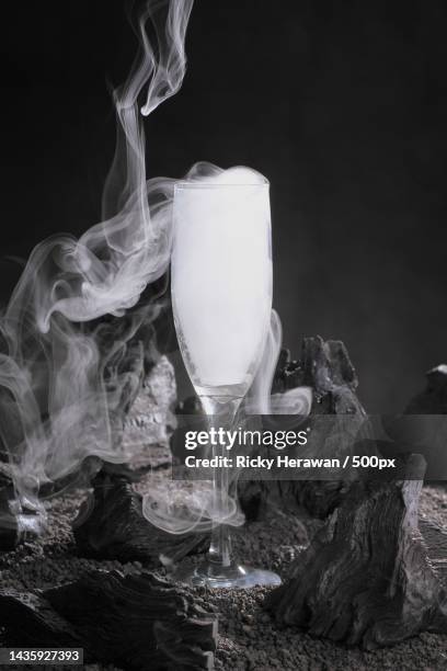 close-up of smoke emitting from drink against black background - dry ice black stock pictures, royalty-free photos & images