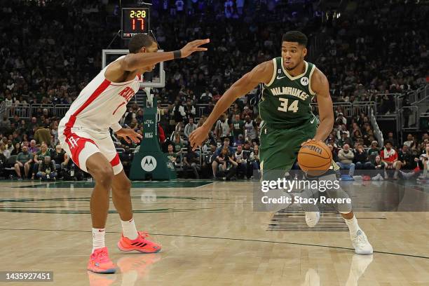 Giannis Antetokounmpo of the Milwaukee Bucks is defended by Jabari Smith Jr. #1 of the Houston Rockets during a game at Fiserv Forum on October 22,...