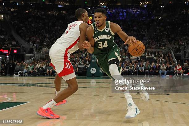 Giannis Antetokounmpo of the Milwaukee Bucks is defended by Jabari Smith Jr. #1 of the Houston Rockets during a game at Fiserv Forum on October 22,...