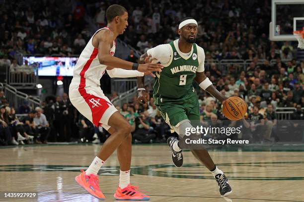 Bobby Portis of the Milwaukee Bucks is defended by Jabari Smith Jr. #1 of the Houston Rockets during a game at Fiserv Forum on October 22, 2022 in...